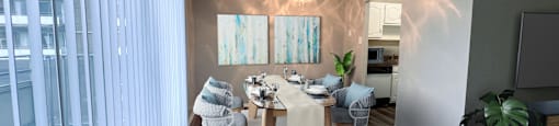 a dining room with a table and chairs and a ceiling fan at Huntington Green Apartments, University Heights, 44118
