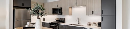 a kitchen with stainless steel appliances and a wooden table