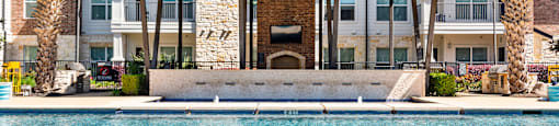 A large house with a pool in front.