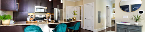 A kitchen with dark brown cabinets and a white counter top.