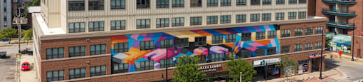 a building with colorful umbrellas on the side of it