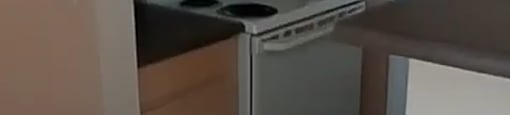 A small kitchen with a white fridge and a white stove.