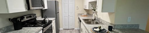 Kitchen with white cabinets and stainless steel appliances at Belmont Ridge Apartments, Monroeville, PA, 15146