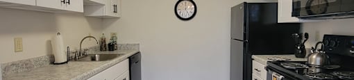 Kitchen with White Cabinets and Black Appliances at Birnam Wood Apartments, Monroeville, PA