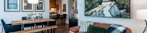 Living and dining room with luxury flooring and modern finishes at La Voile Pointe-Claire apartments in Point-Claire, Quebec