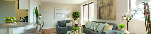 Millside Tower bright, open concept living room with view of kitchen in Milton, ON