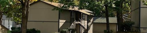 a house with a yard and trees in front of it at Ridgecrest Timbers Apartments, Oregon, 97203