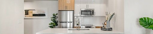 an open kitchen with a large island with four stools