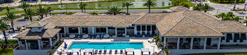 A large house with a pool in the middle of a lake.