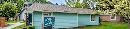 a blue house with a welcome sign in front of it