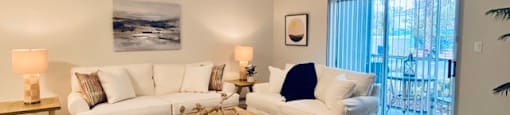 living room with two white couches and a table at Mainstreet Apartments, Clearwater, Florida