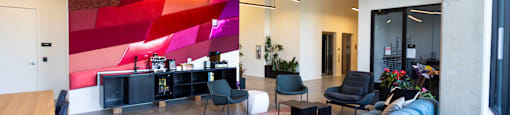 a large lobby with a blue couch and chairs at Analog PDX Apartments, Oregon