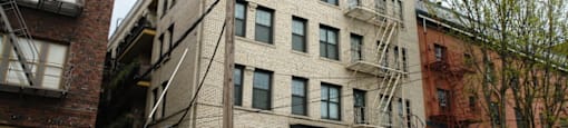 an apartment building on the corner of a city street
