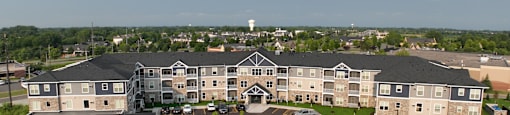 A large building with a parking lot in front of it.