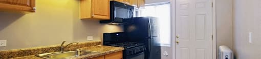 Bright kitchen with black appliances