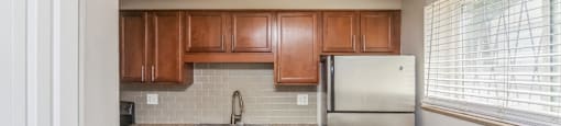 Kitchen with stainless steel appliances and tiled backsplash