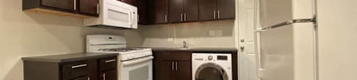 Open kitchen with rich wood cabinets