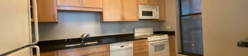 Kitchen featuring granite countertops, dishwasher and gas range