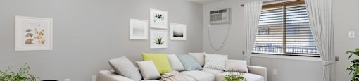 A living room with a white couch and a coffee table at 23–33 Pearl St in Denver, CO