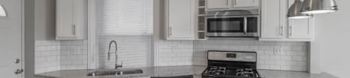 Spacious kitchen with stainless steel appliances and granite countertops