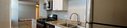 Galley style kitchen with stainless steel appliances - One Bedroom