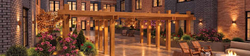 A modern building with a fire pit in the courtyard.