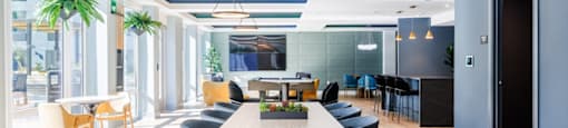 a communal table and chairs in a lobby of a building