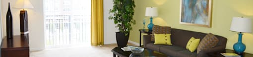 Living Room With Ceiling Fan and Door To Patio or Balcony