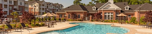 Resort-style saltwater pool with chairs and umbrellas
