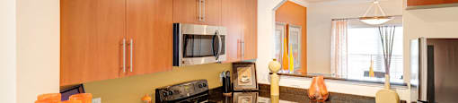 Kitchen with black granite countertops; opening to separate dining room
