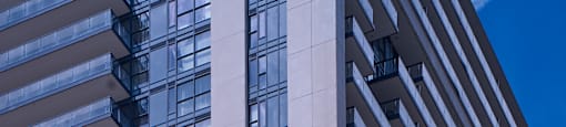 A tall building with a blue sky in the background.