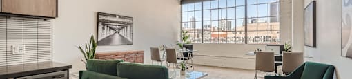A living room with a green couch and a dishwasher.
