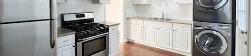 Kitchen with granite counters, wood floors, and washer dryer combo