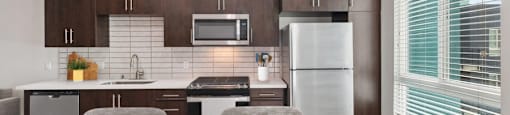 A modern kitchen with a table and chairs.