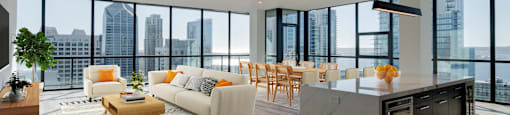a living room with a kitchen and a city view