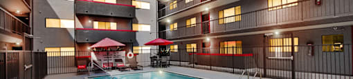 A swimming pool in a courtyard surrounded by buildings.