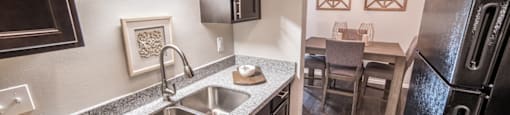 Renovated Kitchen with granite countertops and stainless-steel sink at Chelsea Village Apartments