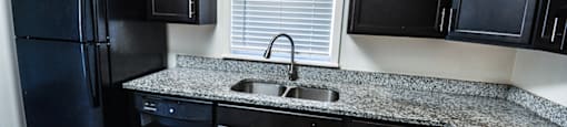 Kitchen in a townhome with cabinets and granite countertops at Carriage House Evansville.