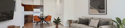 A living room with a grey couch, a coffee table, and a television.