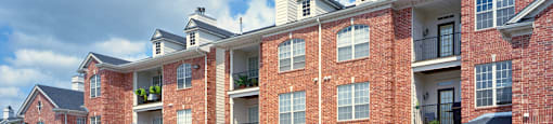 Luxury apartments with golf course views, red brick exteriors, attached garages, and access to Big Papio Trail at The Biltmore Apartments in Omaha, Nebraska