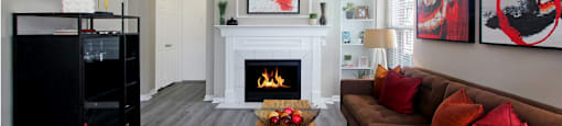 Luxury apartments with wood plank floors, gas fireplaces, built-in shelves, and gray wall color at Rockledge Oaks Apartments in Lincoln, Nebraska