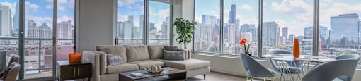 the living room of an apartment with a view of the city
