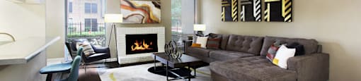 Spacious floor plan with wood-burning fireplace, breakfast bar, oversized windows and wood plank floors at Woodlake on the Bayou Apartments in Houston