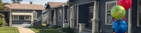 A house is for rent with a sign in front of it.