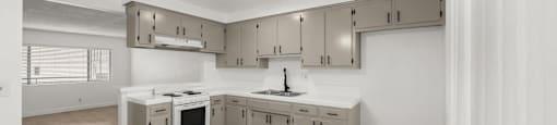 A kitchen with a ceiling fan and a logo for Beach Front Property Management.