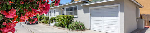 a home with a white garage door and a driveway