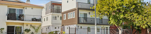 A row of modern houses with a street in front.