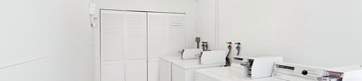 A white bathroom with a sink and a toilet.