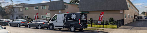 A street view with cars and a building with the text "BEACH FRONT PROPERTY MANAGEMENT".