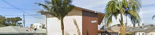 a house with palm trees in front of it